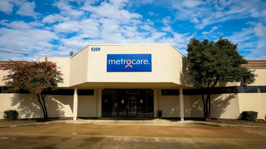 Image of building with blue sky and clouds and Metrocare sign